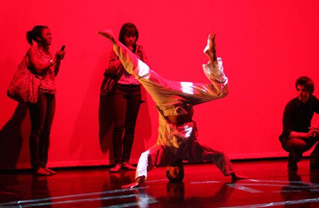 A person doing a handstand on a stage.