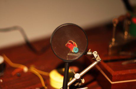 A magnifying glass sits on top of a table.