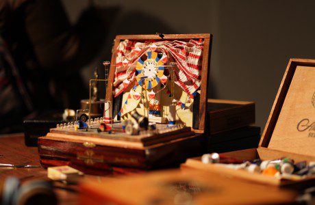 A wooden box with a model of a ship on it.