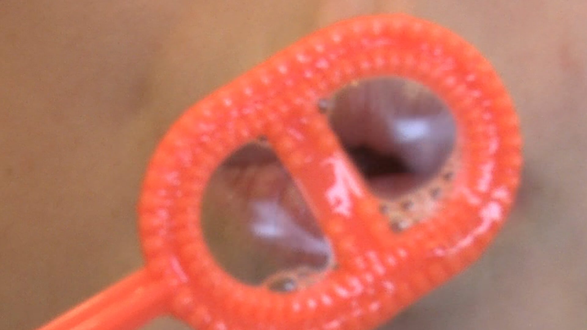 An extreme close-up of someone blowing a bubble