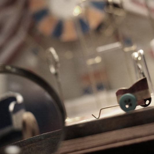 A toy car on a table with a magnifying glass.