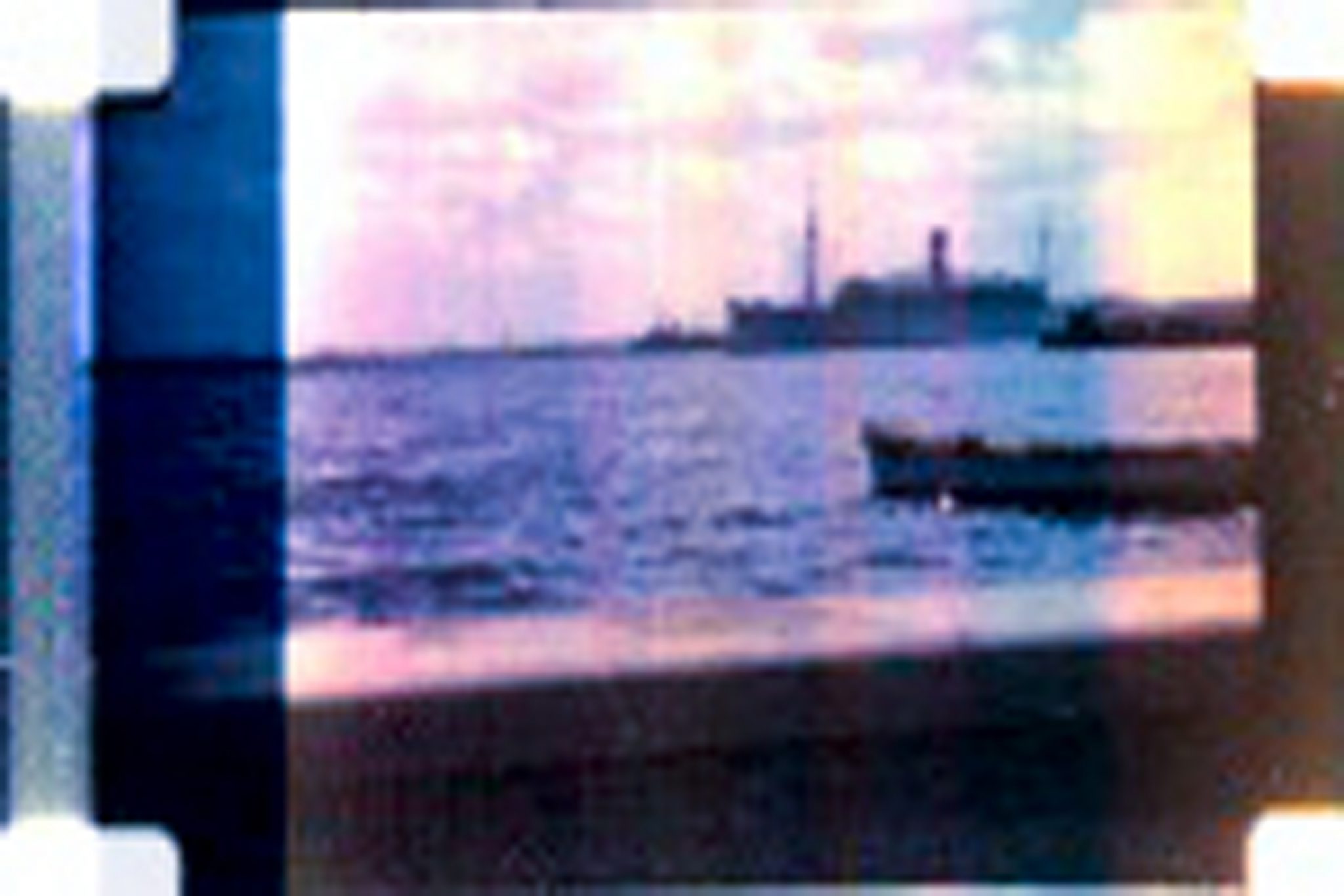 Image of a blur photograph of ocean, ships and boat.