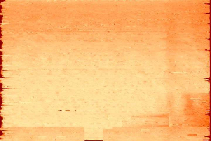 A photo of an orange background with a smudge on it.