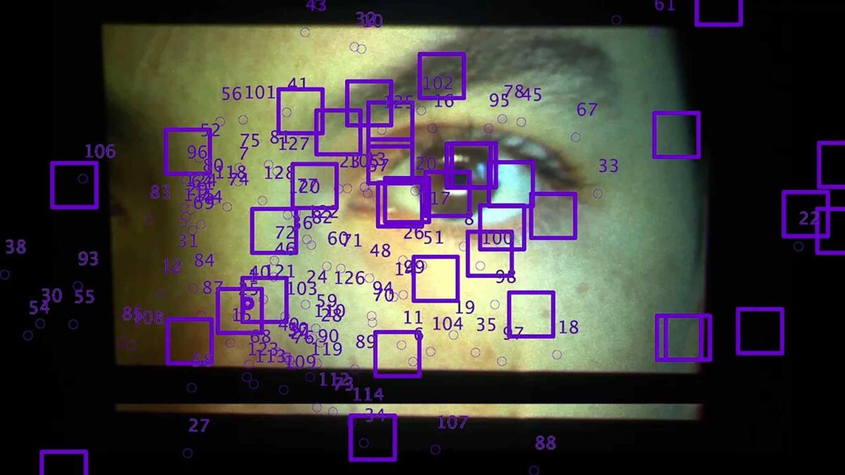 An image of a person's face with purple squares.