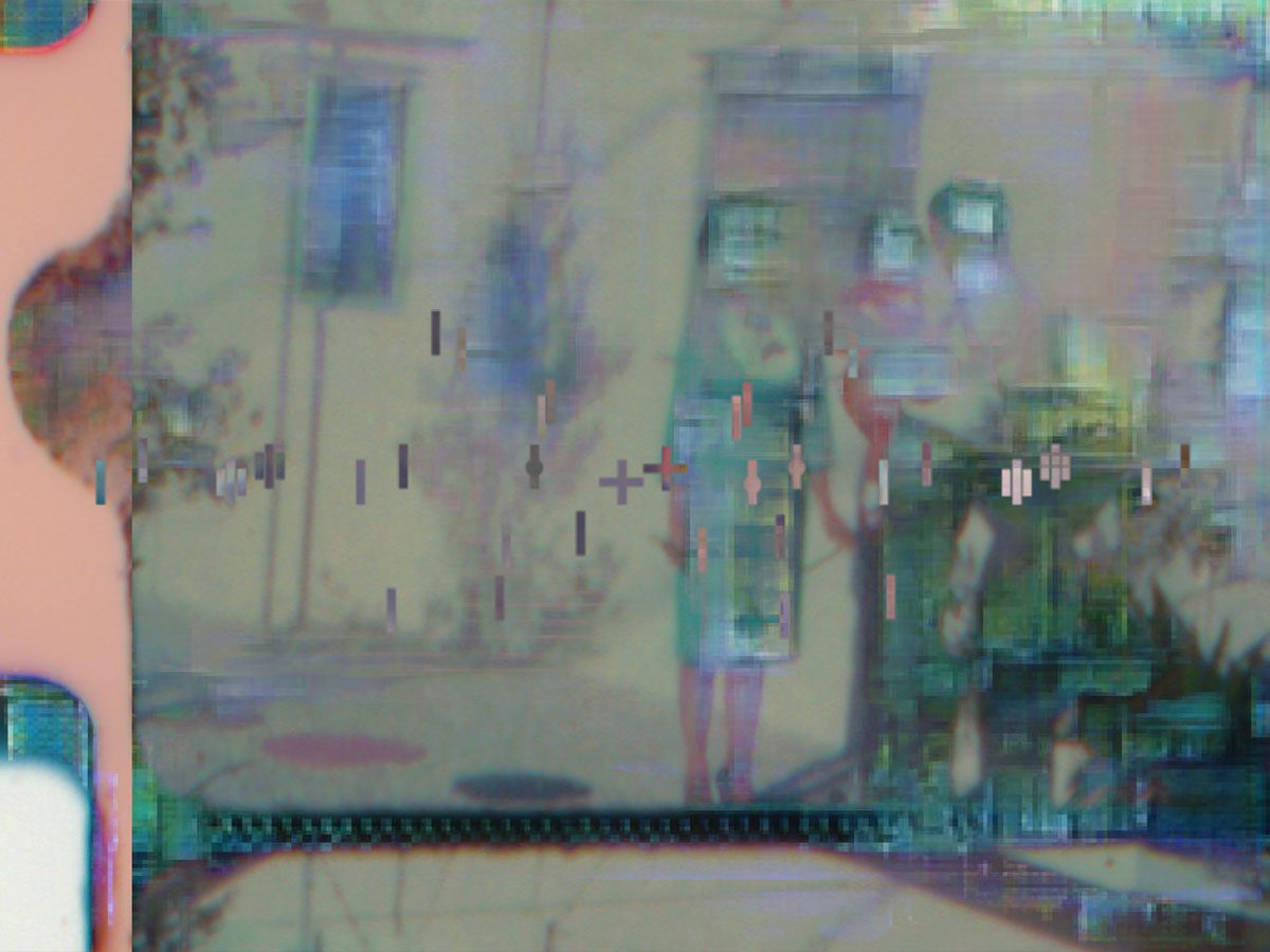 A pixelated image of a woman and a man standing in front of a building.