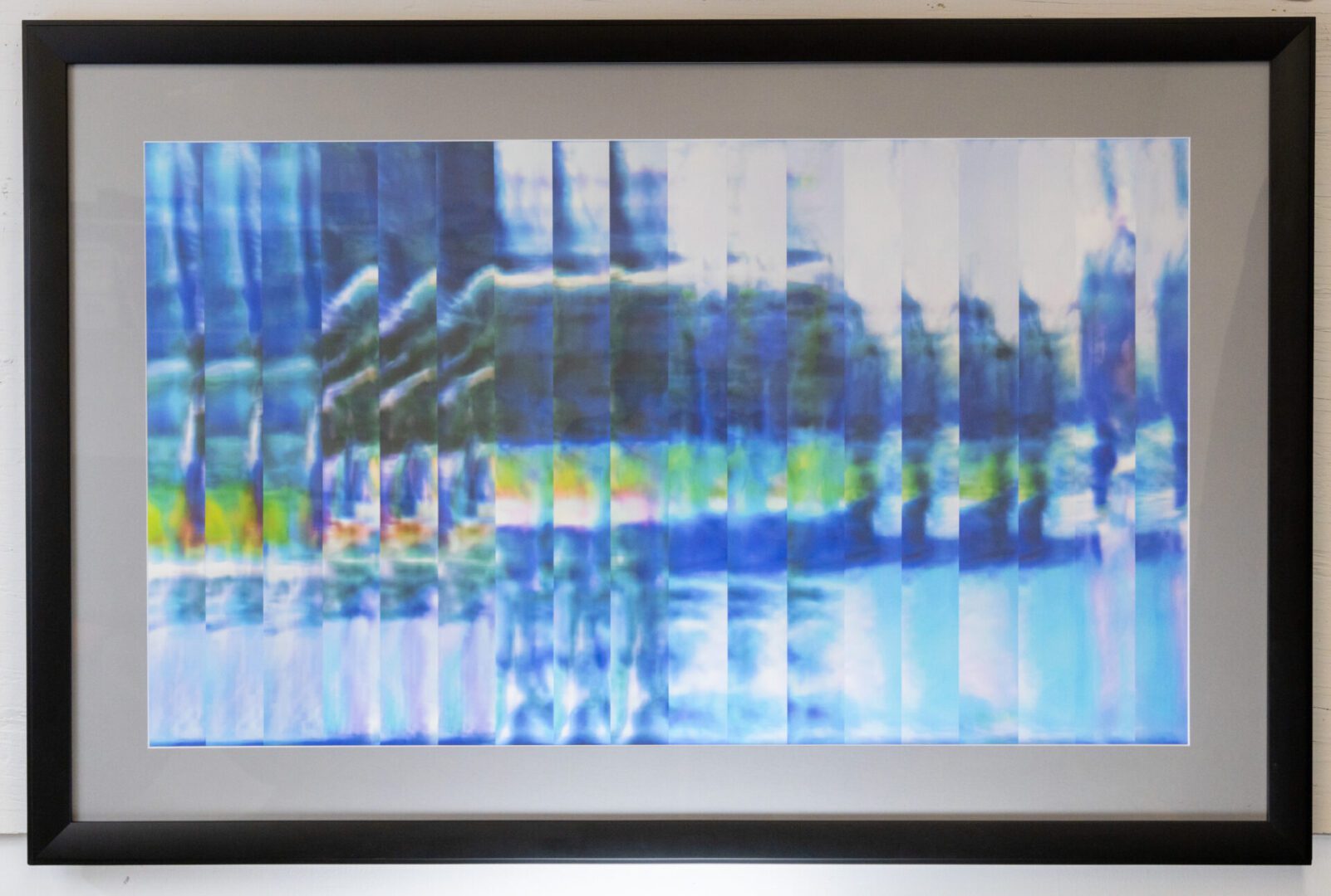 A framed painting with blue and green stripes.