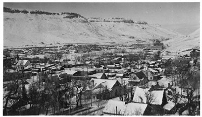 aerial black and white photograph of town with North Table mountain in background