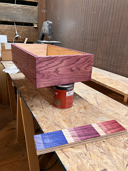 red stained wooden box in workshop